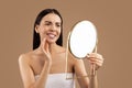 Unhappy half-naked woman looking at mirror and touching her face Royalty Free Stock Photo