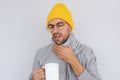 Unhappy handsome bearded male having sore throat influenza. Portrait of sick man touching his neck grimacing suffering from pain, Royalty Free Stock Photo