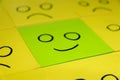 Unhappy and happy concept. Background of green sticky notes. Unhappy sticky note is among happy sticky notes Royalty Free Stock Photo
