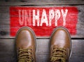 Unhappy - Happy. Top View of Boot on wooden background