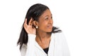 Unhappy hard of hearing woman placing hand on ear Royalty Free Stock Photo