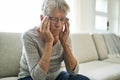 Unhappy headache Retired Senior Woman Sitting On Sofa At Home Royalty Free Stock Photo