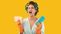 Unhappy Housewife Crying Holding Detergent Bottle Standing On Yellow Background