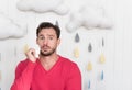 Unhappy ill man standing against cloudy background Royalty Free Stock Photo