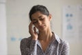 Unhappy Indian businesswoman touching temples, suffering from headache Royalty Free Stock Photo