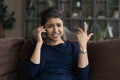 Unhappy Indian woman talking on phone, hearing bad news Royalty Free Stock Photo