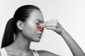 Unhappy japanese woman rubbing red sore nose Royalty Free Stock Photo