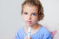 Unhappy kid girl with syringe medicine dose