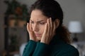 Unhappy Latino woman feel unhealthy suffer from migraine