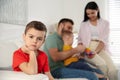 Unhappy little boy feeling jealous while parents spending time with his baby brother Royalty Free Stock Photo