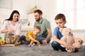 Unhappy little boy feeling jealous while parents spending time with his baby brother Royalty Free Stock Photo