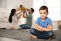 Unhappy little boy feeling jealous while parents spending time with his baby brother Royalty Free Stock Photo