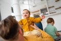 Unhappy little boy feeling jealous while perent spending time with his baby sister at home Royalty Free Stock Photo