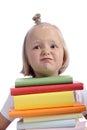 Unhappy little girl with stack of books