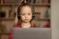 Unhappy Little Schoolgirl Video Calling Via Laptop Learning Online Indoors Royalty Free Stock Photo