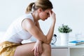 Unhappy lonely depressed young woman sitting on bed at home. Depression concept. Royalty Free Stock Photo