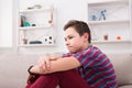 Bored unhappy teenage boy sitting at home Royalty Free Stock Photo