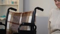 Unhappy lonely woman sitting in wheelchair in nursing home, feeling homesick