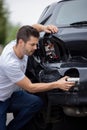 Unhappy Male Driver Inspecting Damaged Car After Accident Royalty Free Stock Photo