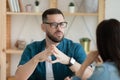 Unhappy male employee think talking with colleague at meeting