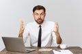 Unhappy male working in the office, looking at the camera, front view, isolated on white.