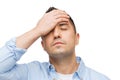 Unhappy man with closed eyes touching his forehead Royalty Free Stock Photo