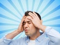 Unhappy man with closed eyes touching his forehead Royalty Free Stock Photo