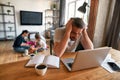 Unhappy man feel distressed working on laptop at home