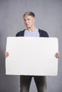 Unhappy man showing white blank panel.