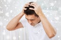 Unhappy man suffering from head ache at home Royalty Free Stock Photo