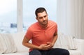 Unhappy man suffering from stomach ache at home Royalty Free Stock Photo