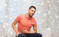 Unhappy man suffering from stomach ache at home Royalty Free Stock Photo