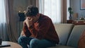 Unhappy man worried call sitting couch close up. Upset guy talking mobile phone Royalty Free Stock Photo