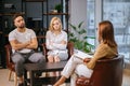 Unhappy married couple talking to family counselor before breaking up Royalty Free Stock Photo