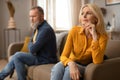 Unhappy Mature Couple Having Marital Crisis Sitting On Sofa Indoor
