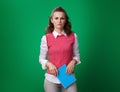 Unhappy student woman with blue notebook isolated on green Royalty Free Stock Photo