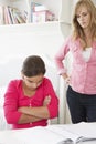 Unhappy Mother Telling Off Daughter For Not Doing Homework