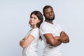 Unhappy multiracial couple standing back to back after conflict Royalty Free Stock Photo