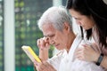 Unhappy old elderly grandmother crying tears looking at photograph of family with  sorrow,sad asian senior people holding photo Royalty Free Stock Photo