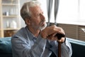 Unhappy old man with cane look in distance mourning Royalty Free Stock Photo