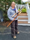 Unhappy Older Woman Holding Broken Shovel Handle