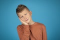 Unhappy preteen boy suffering from tooth ache, touching cheek with hand Royalty Free Stock Photo