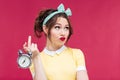 Unhappy pretty young woman holding alarm clock Royalty Free Stock Photo