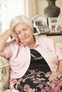 Unhappy Retired Senior Woman Sitting On Sofa At Home Royalty Free Stock Photo