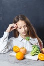 Unhappy russian women is on dieting time looking at broccoli on the fork. girl do not want to eat vegetables and dislike Royalty Free Stock Photo