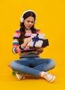 Unhappy sad teenager girl. Emotional teenager child hold gift on birthday. Funny kid girl holding gift boxes celebrating Royalty Free Stock Photo