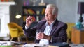 Unhappy sad and troubled elderly man looks at pill in hand Royalty Free Stock Photo