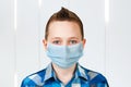 Unhappy, sad young boy wearing a protective face mask prevent virus infection or pollution Royalty Free Stock Photo