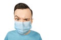 Unhappy, sad young guy, wearing a protective face mask prevent virus infection or pollution on white isolated background Royalty Free Stock Photo