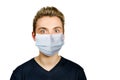 Unhappy, sad young guy wearing a protective face mask prevent virus infection or pollution on white isolated background Royalty Free Stock Photo